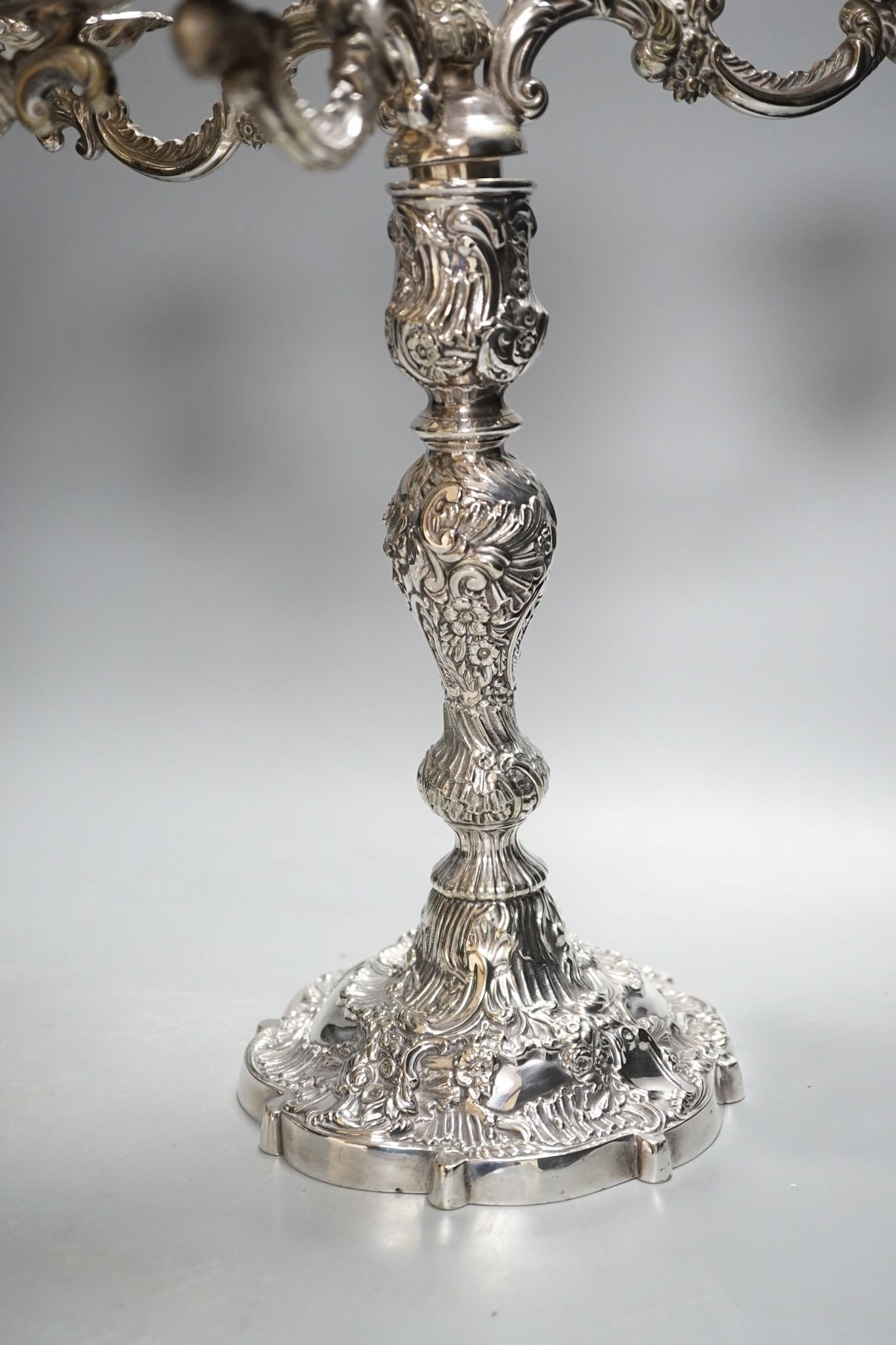 A pair of plated embossed three branch candelabra, 43cm